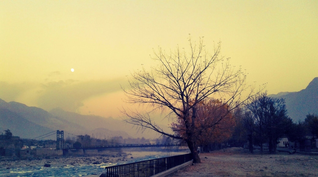 A starting winter's evening along the Gilgit River, Gilgit-Baltistan, Northern Areas of Pakistan. Moon in the background. #WinterWonders