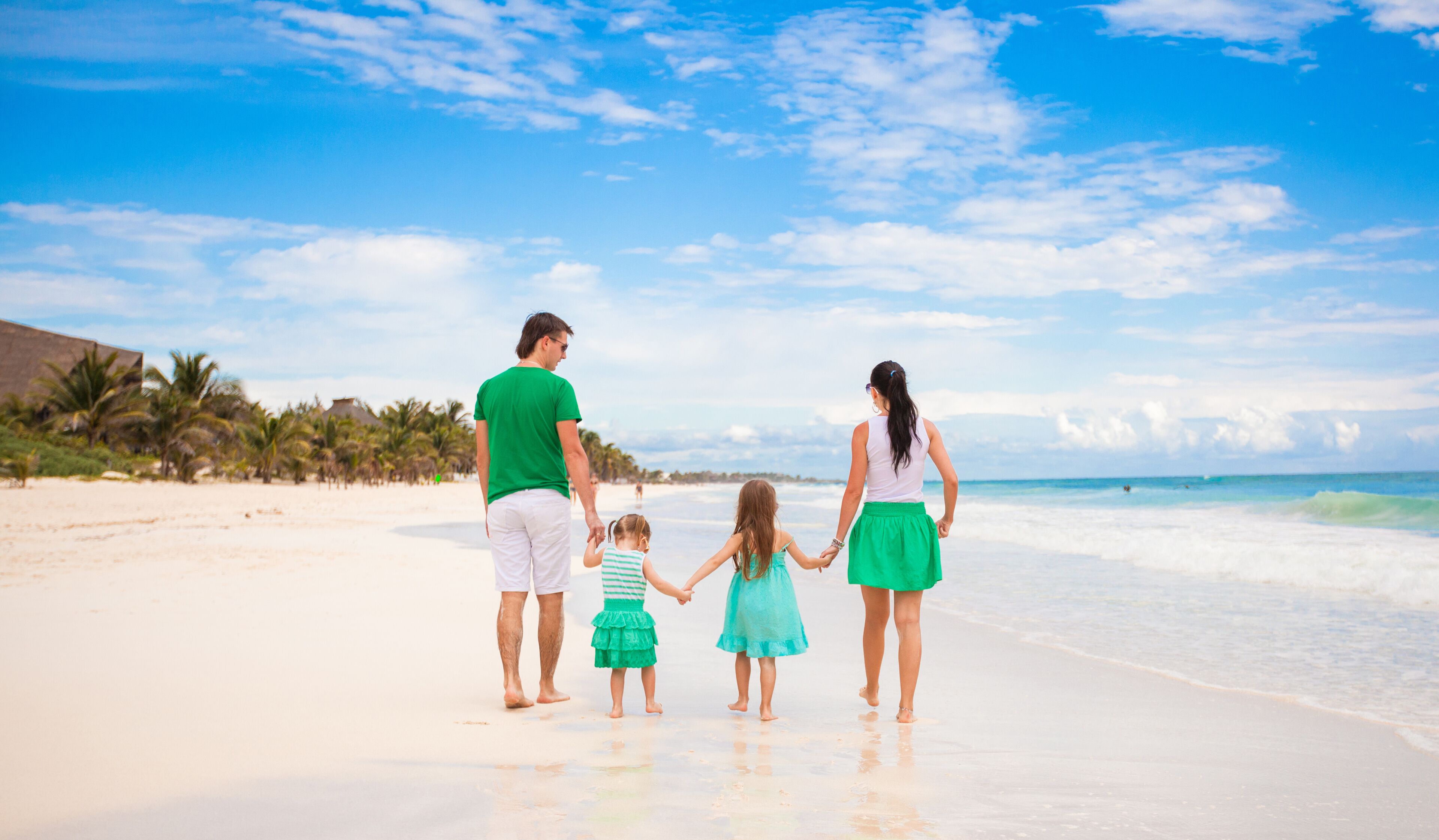 Back view of young family looking to the sea in Mexico beach
