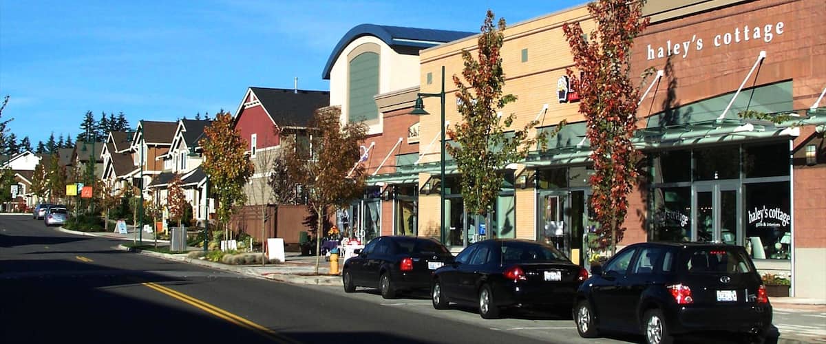 A street lined with buildings, including a cafe named 'Haley's Cottage'.