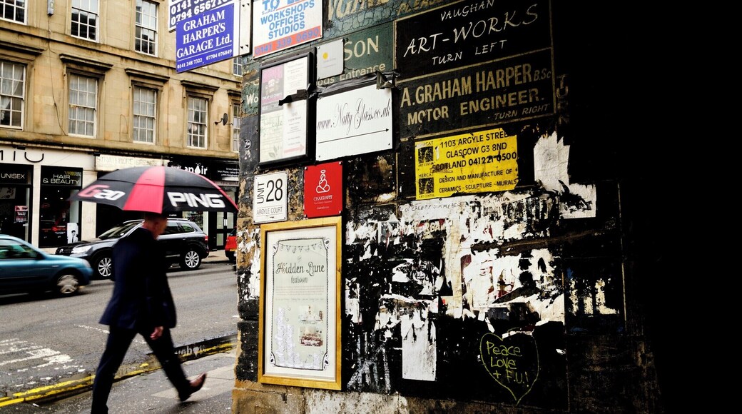 This lane through the tenements leads into a courtyard with many places to visit.
Finnieston has lots of fantastic bars and eateries, yet still has an off licence where they push your purchases through a small hole in the barsa along the counter.