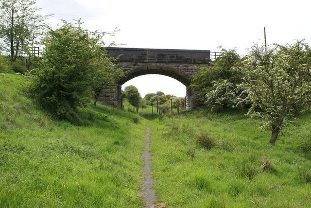 Bridge at Balquharrage This is the trackbed of the Kelvin Valley Railway, which ran from Maryhill (outside Glasgow) to the original Kilsyth station - which was replaced by the town's swimming pool. Kirkintilloch Road crosses above the former track, and the walkway here (which commences a little east of Birdston at the junction with the Campsie Branch of the Edinburgh to Glasgow Railway) ends abruptly here, with a fence preventing any further progress along the line to Torrance. A gate has been helpfully provided to at least allow you access to the road. The line opened in 1879, and this section of track closed in 1962 and the lines lifted.