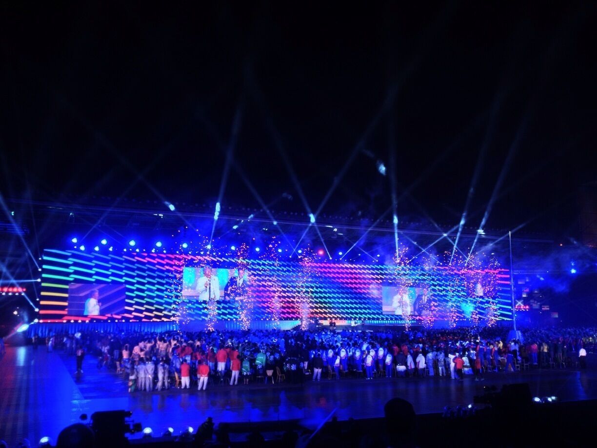 Commonwealth Games opening ceremony. Athletes watching Rod Stewart perform. 