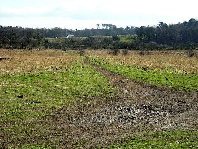 Muddy Track, Darnley. Muddy track on ground between DIY store and M77.
