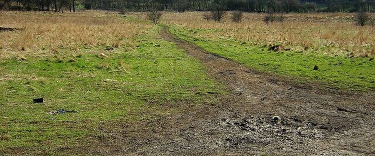 Muddy Track, Darnley. Muddy track on ground between DIY store and M77.