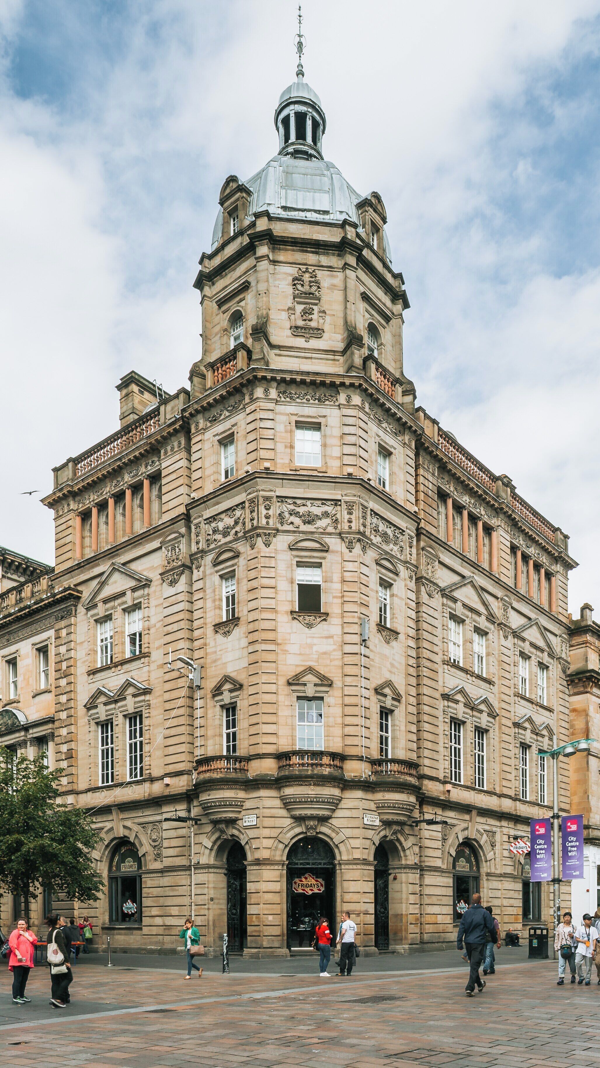 Historical architecture and lively atmosphere on Buchanan Street in City Centre Glasgow, Scotland, showcasing shops and pedestrians during a vibrant day