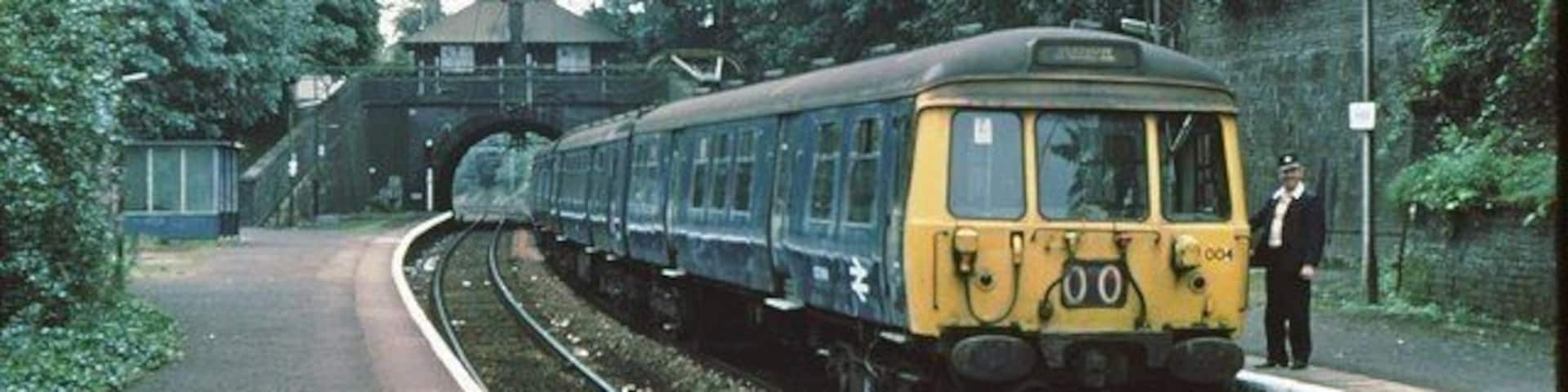 Kirkhill railway station Original description: Kirkhill station 1979 Glasgow area "blue train" awaits the photographer before returning to Glasgow Central.