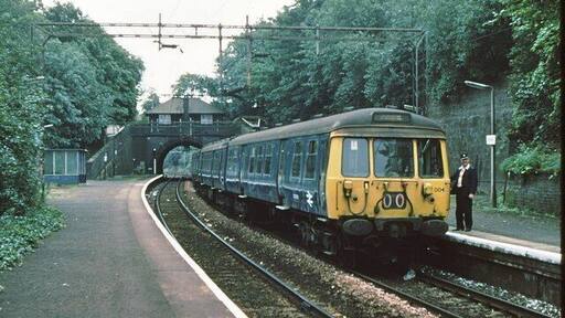Kirkhill railway station Original description: Kirkhill station 1979 Glasgow area "blue train" awaits the photographer before returning to Glasgow Central.