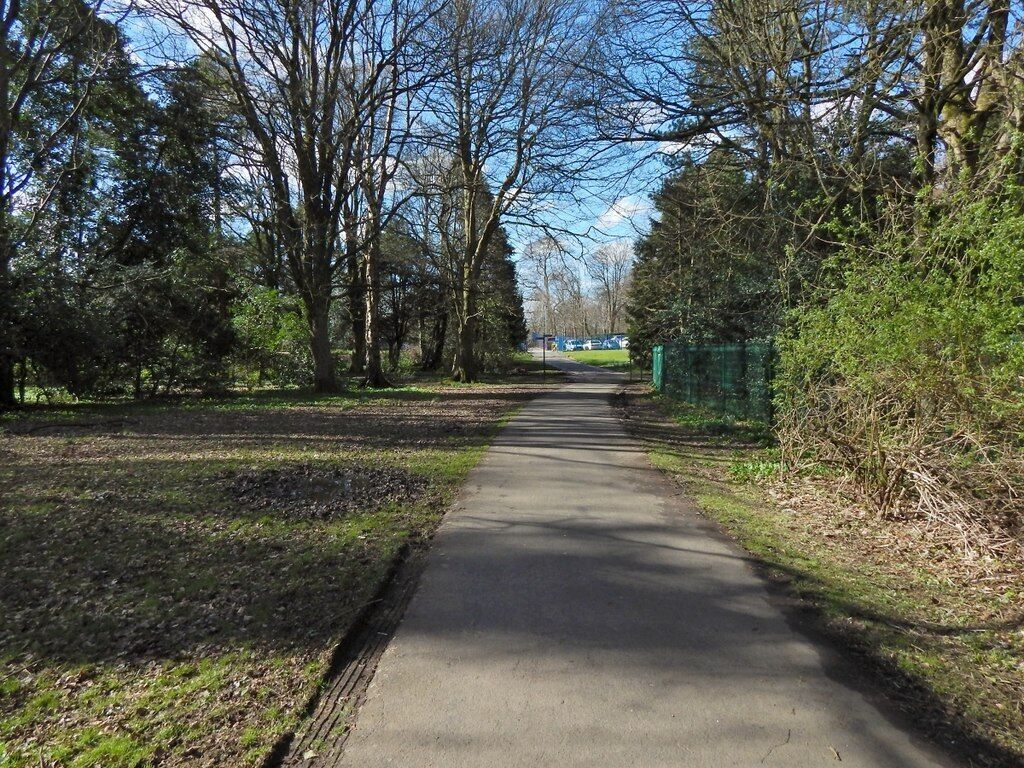 Rosshall Park. Not far ahead is a footpath junction. From there, the path straight ahead leads to the park entrance from Crookston Road, while to the left is the river walk, and to the right is a path to Rosshall Gardens.