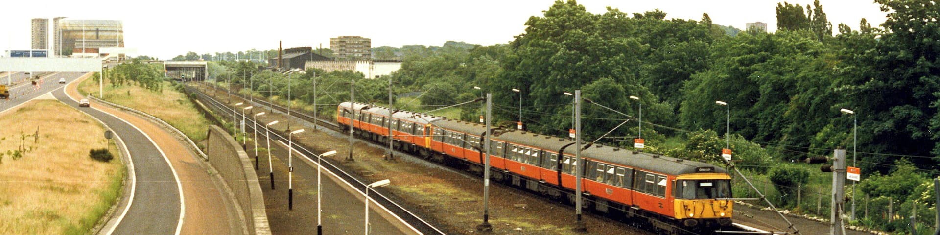 Cardonald station, 1986. View eastward beside the M8 motorway, towards Glasgow Central: ex-Caledonian & GSW Joint Glasgow Central/St Enoch - Paisley etc. main line. The Class 314 EMU train is on a Glasgow Central - Gourock (Inverclyde Line) service.