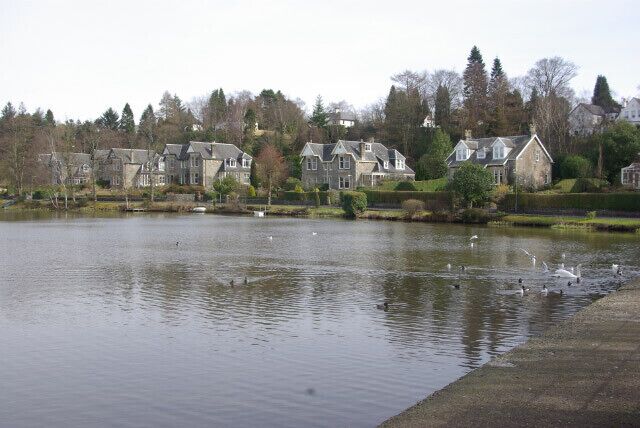 Tannoch Loch Small loch surrounded by suburban housing.