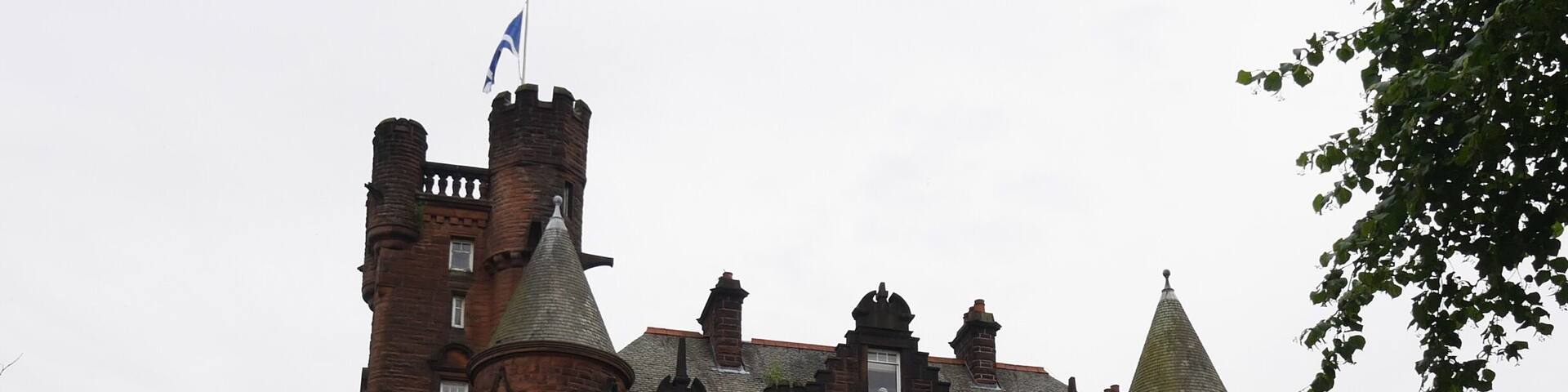 This castle is now a hotel in Glasgow. The grounds it sits on are lush, and within good walking distance from the train