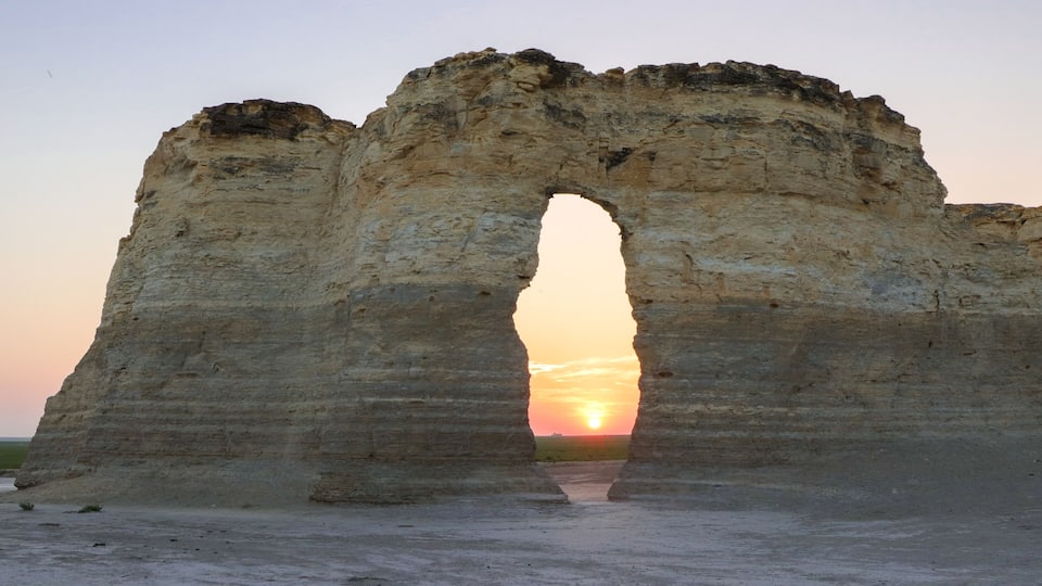 Monument Rocks Keyhole at sunset. Chalk pyramid geologic formation in western Kansas seen as sun sets on the Kansas High Plains.