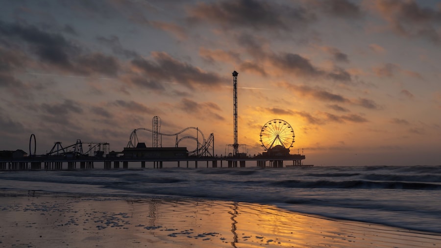 Sunrise at the historic pleasure pier in Galveston, TX. I visited Galveston for a brief business trip and had the opportunity to take a couple of photos on two mornings. This morning was very windy but despite the forecast the sun revealed itself as planned behind the ferris wheel