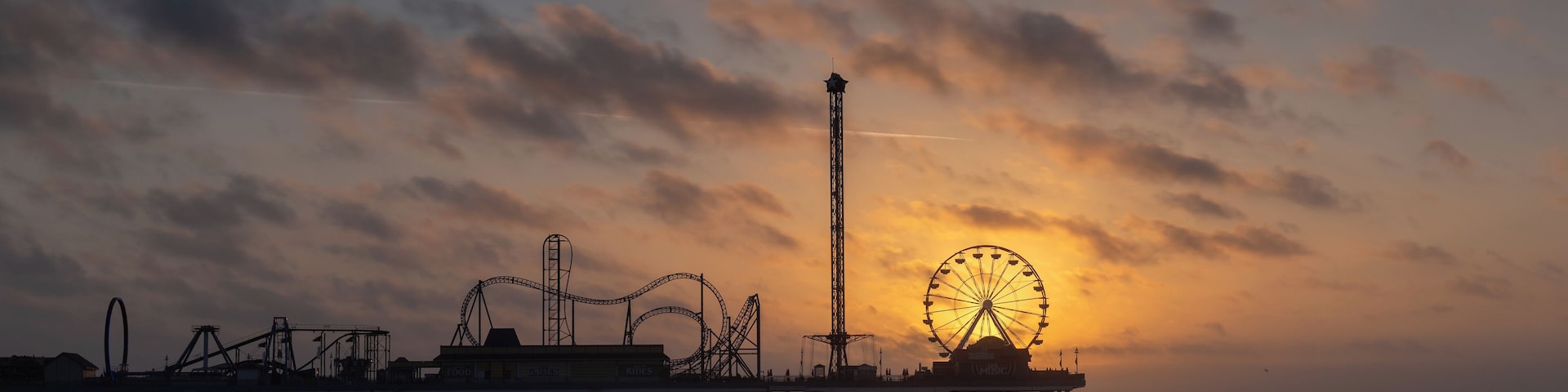 Sunrise at the historic pleasure pier in Galveston, TX. I visited Galveston for a brief business trip and had the opportunity to take a couple of photos on two mornings. This morning was very windy but despite the forecast the sun revealed itself as planned behind the ferris wheel