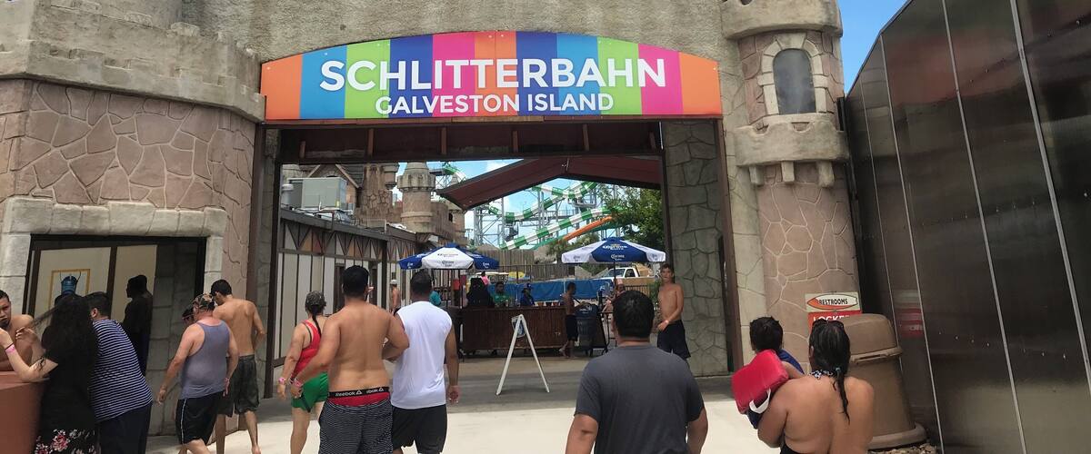 A castle-like entrance with a sign reading "SCHLITTERBAHN GALVESTON ISLAND".