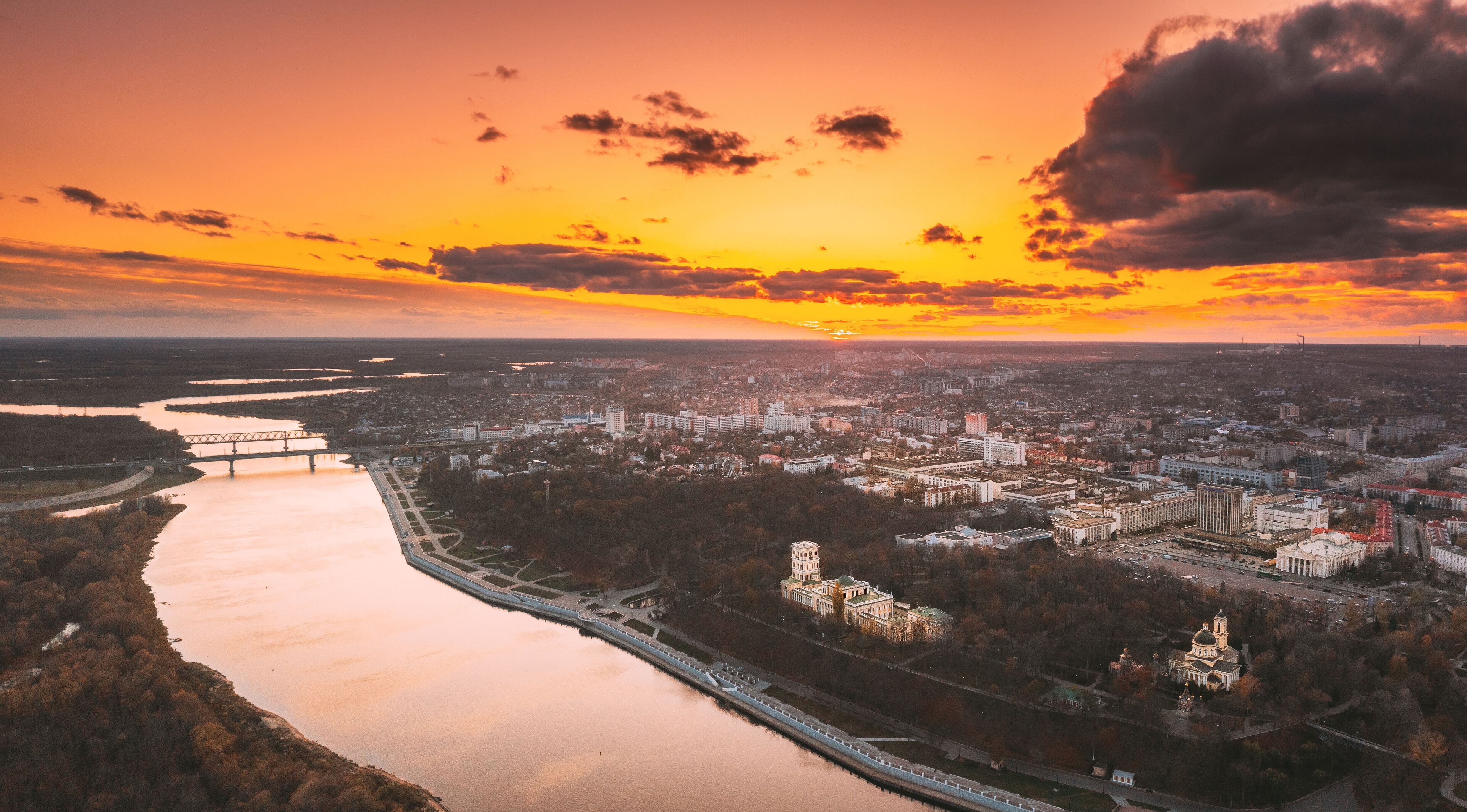 Gomel, Belarus. Aerial View Of City Park Paskeviches Palace And Homiel Cityscape Skyline In Autumn Evening. Residential District And River During Sunset. Bird's-eye View