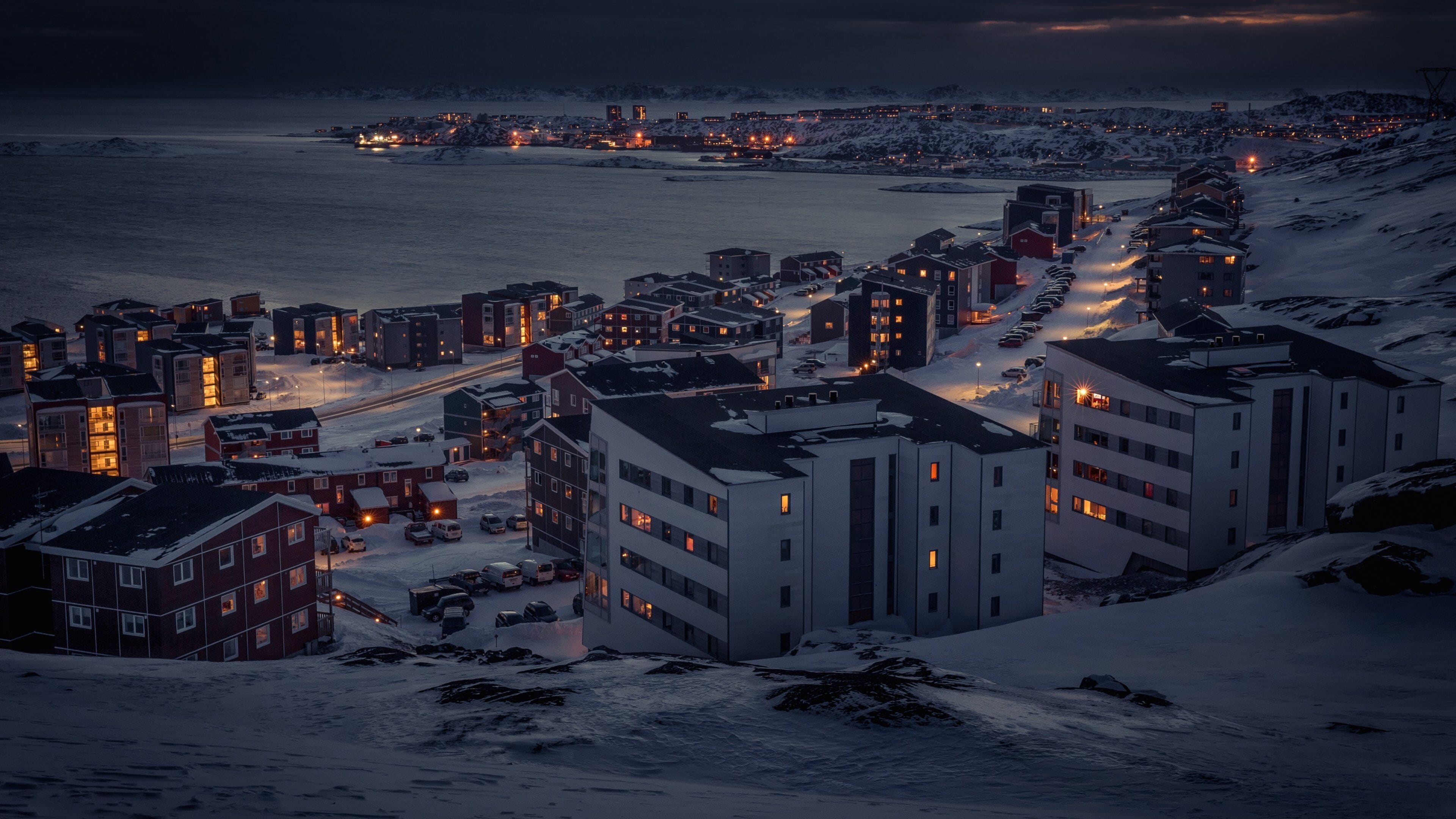 Nuuk featuring snow, a city and night scenes