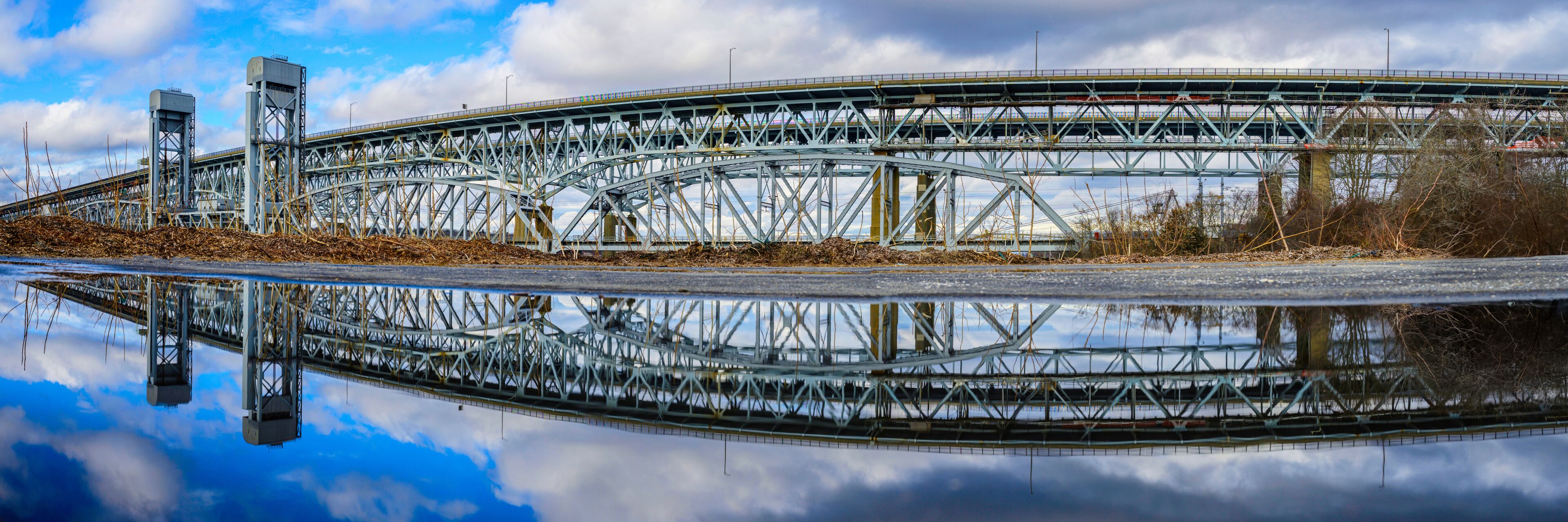 Gold Star Memorial Bridge in New London, Connecticut, the arching landmark suspending bridge over the Thames River, reflected symmetrical shapes over the water