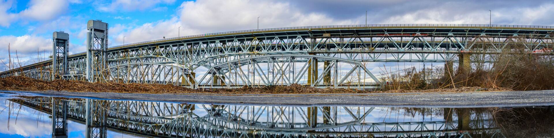 Gold Star Memorial Bridge in New London, Connecticut, the arching landmark suspending bridge over the Thames River, reflected symmetrical shapes over the water