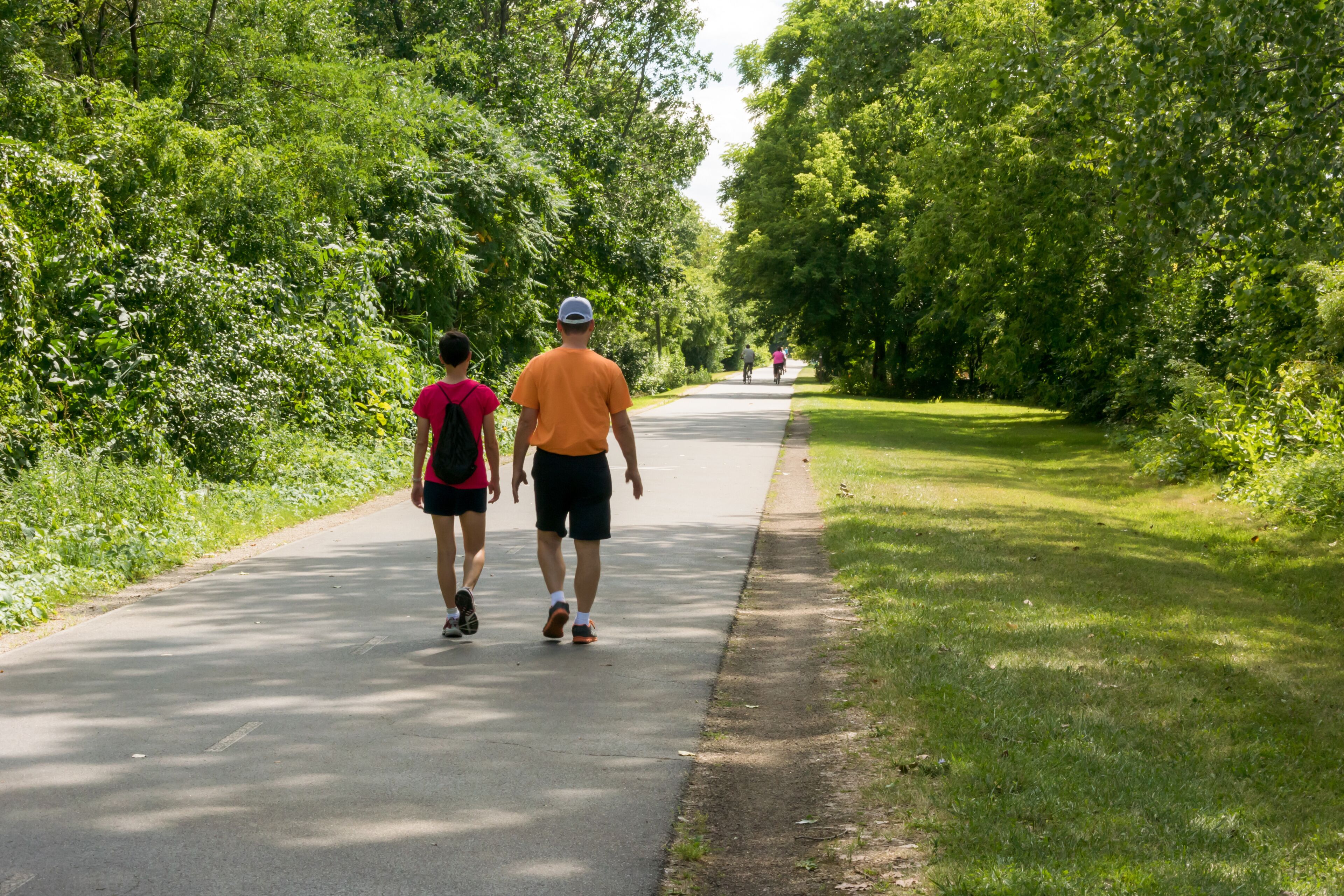 Walkers Enjoy The Fox River Trail Near De Pere, Wisconsin, In Summer