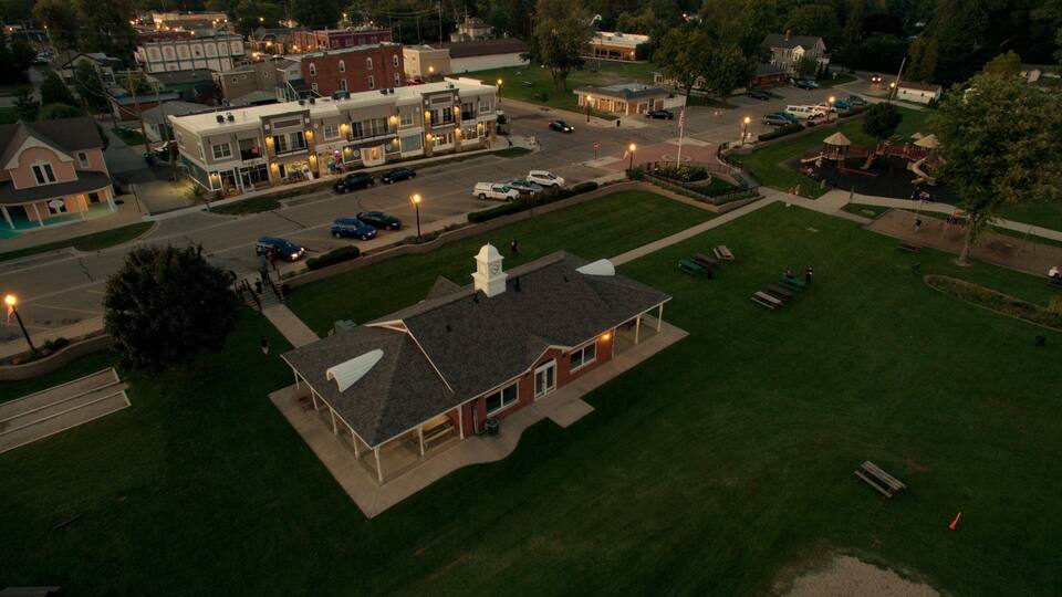 A town square with a central building, surrounding streets, and a park area.