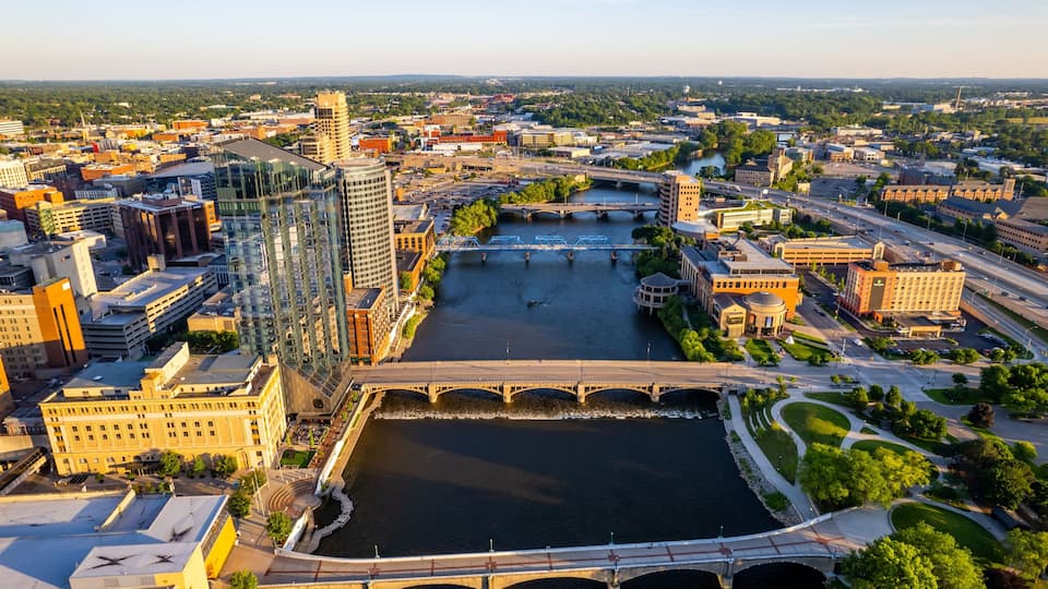 A cityscape with a river, bridges, and modern buildings.