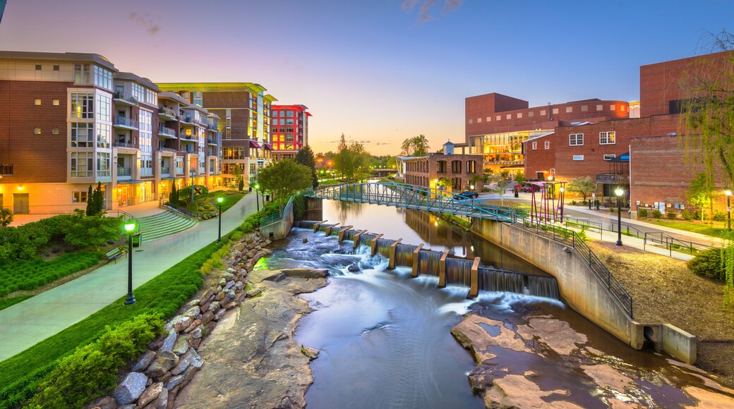 Greenville, South Carolina, USA downtown cityscape on the Reedy River at dusk