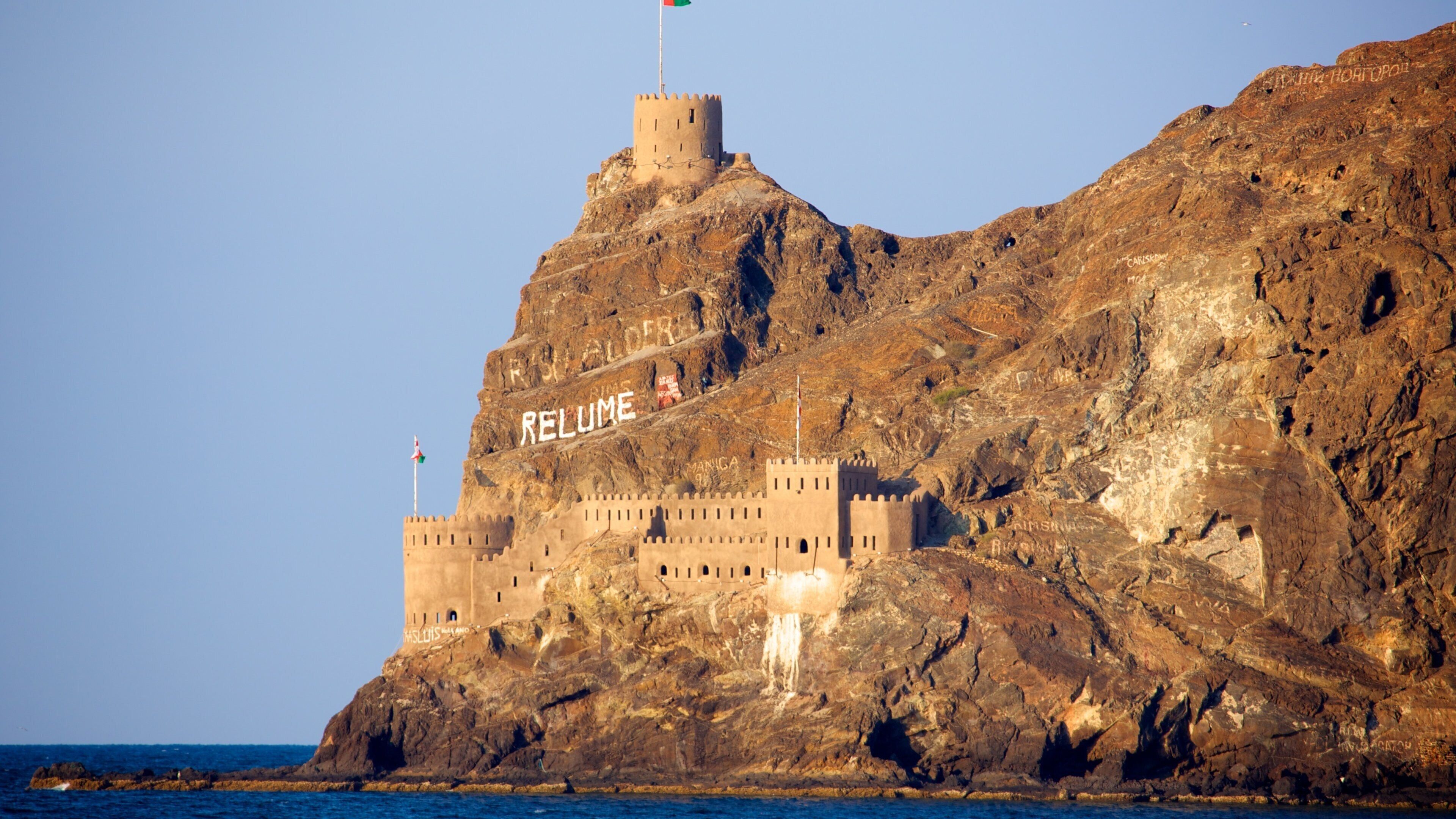 Oman featuring mountains, rugged coastline and heritage elements