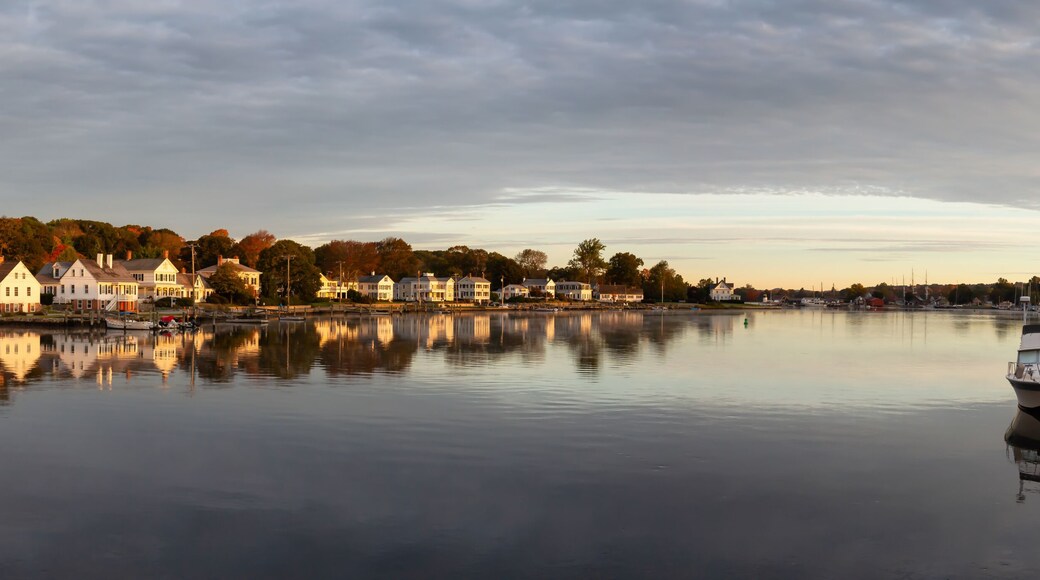 Panoramic view of residential homes by the Mystic River during a vibrant sunrise. Taken in Mystic, Stonington, Connecticut, United States.