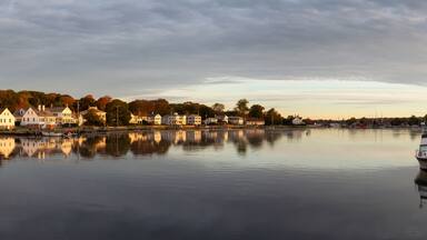 Panoramic view of residential homes by the Mystic River during a vibrant sunrise. Taken in Mystic, Stonington, Connecticut, United States.