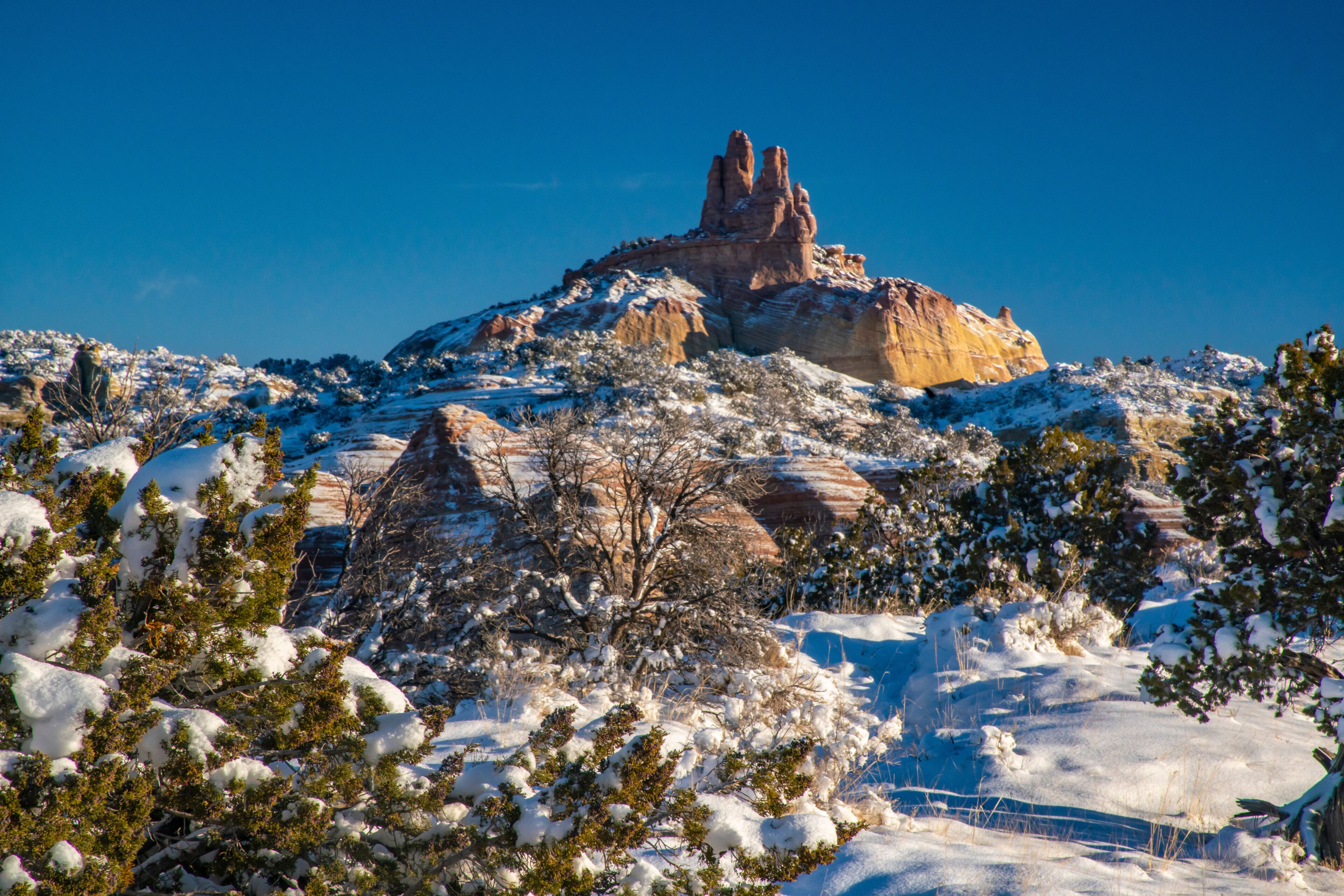 USA, New Mexico, Gallup, Red Rock Park. Church Rock in winter sunrise.