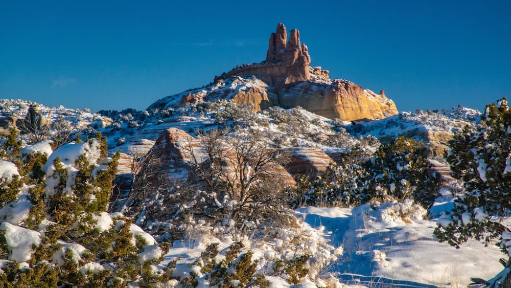 USA, New Mexico, Gallup, Red Rock Park. Church Rock in winter sunrise.