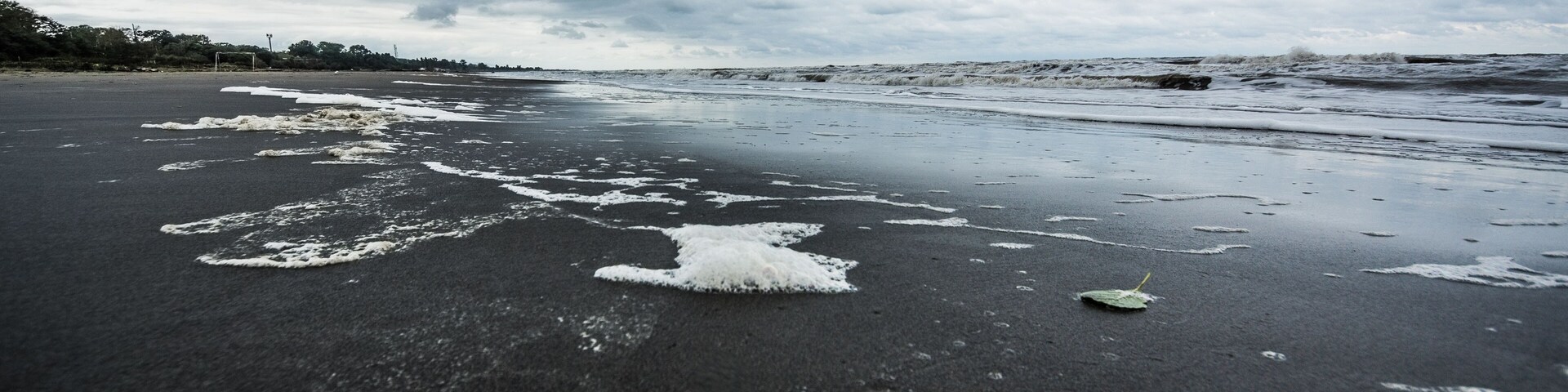 Caspian sea under blue sky in early September, snag on the beach