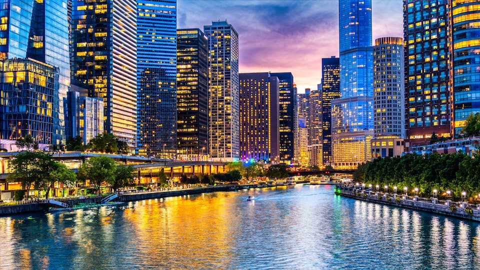 A cityscape with a river, high-rise buildings, and a bridge.