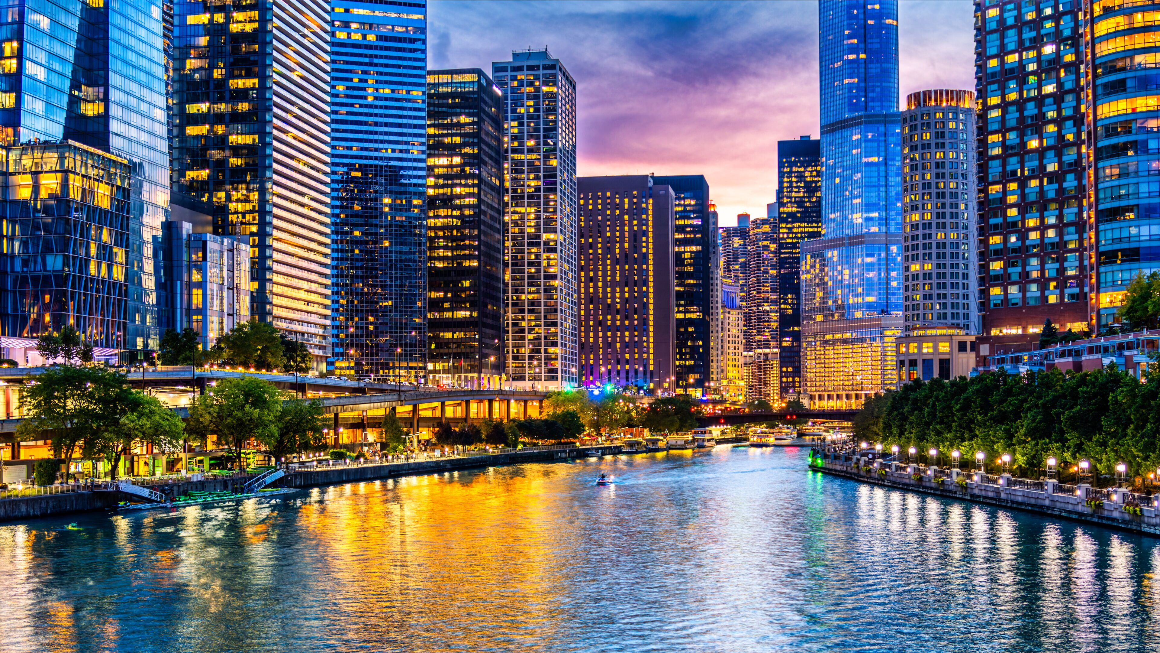 A cityscape with a river, high-rise buildings, and a bridge.