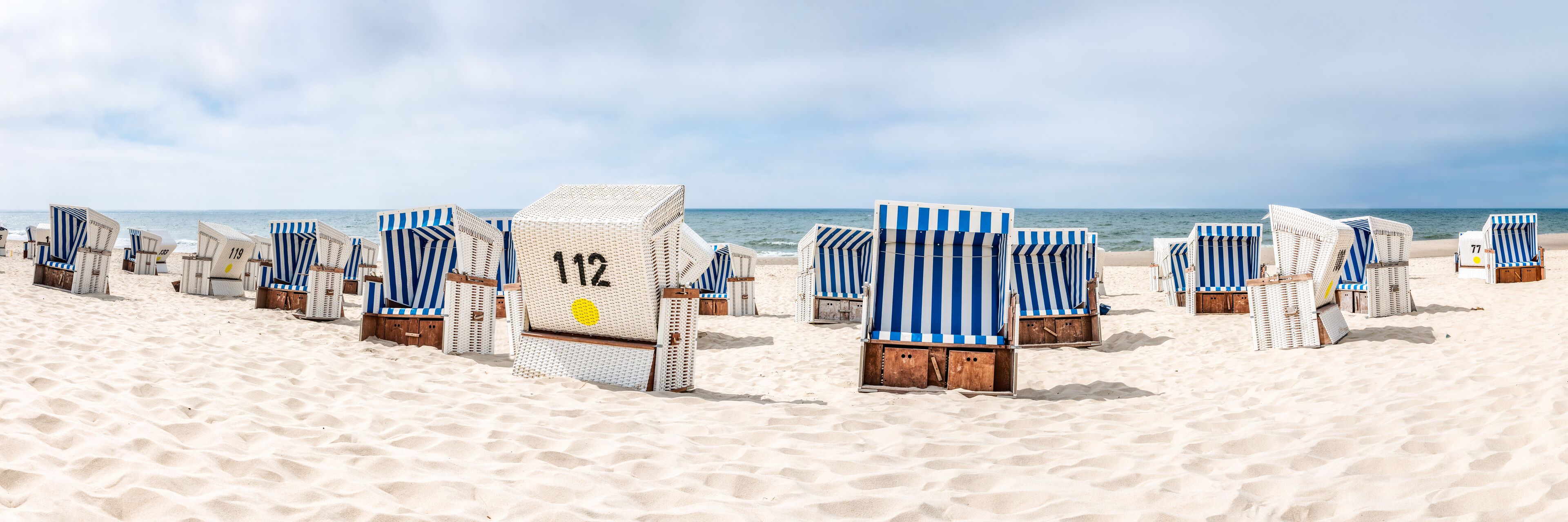 Roofed wicker beach chairs at the beach, North Sea, Germany