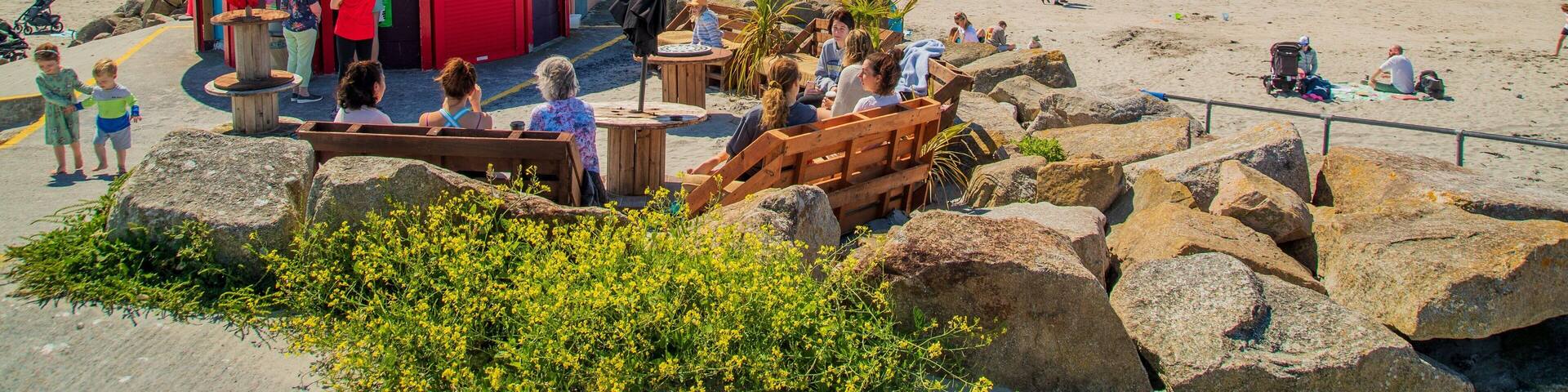 Galway featuring a sandy beach and general coastal views as well as a small group of people