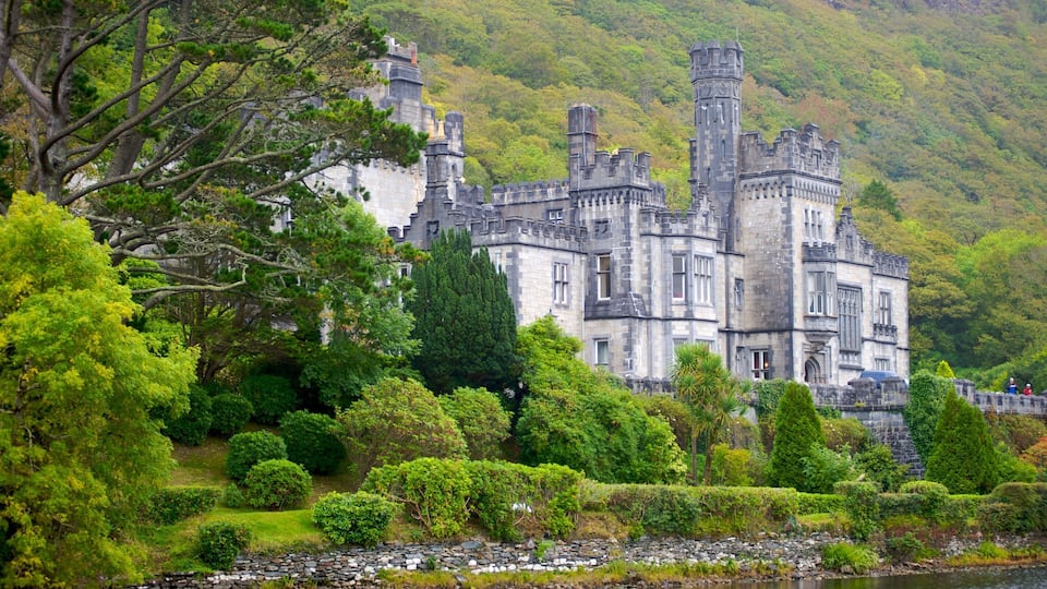 A castle surrounded by lush greenery and a river.