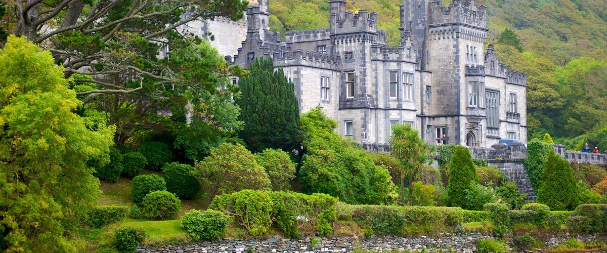 A castle surrounded by lush greenery and a river.