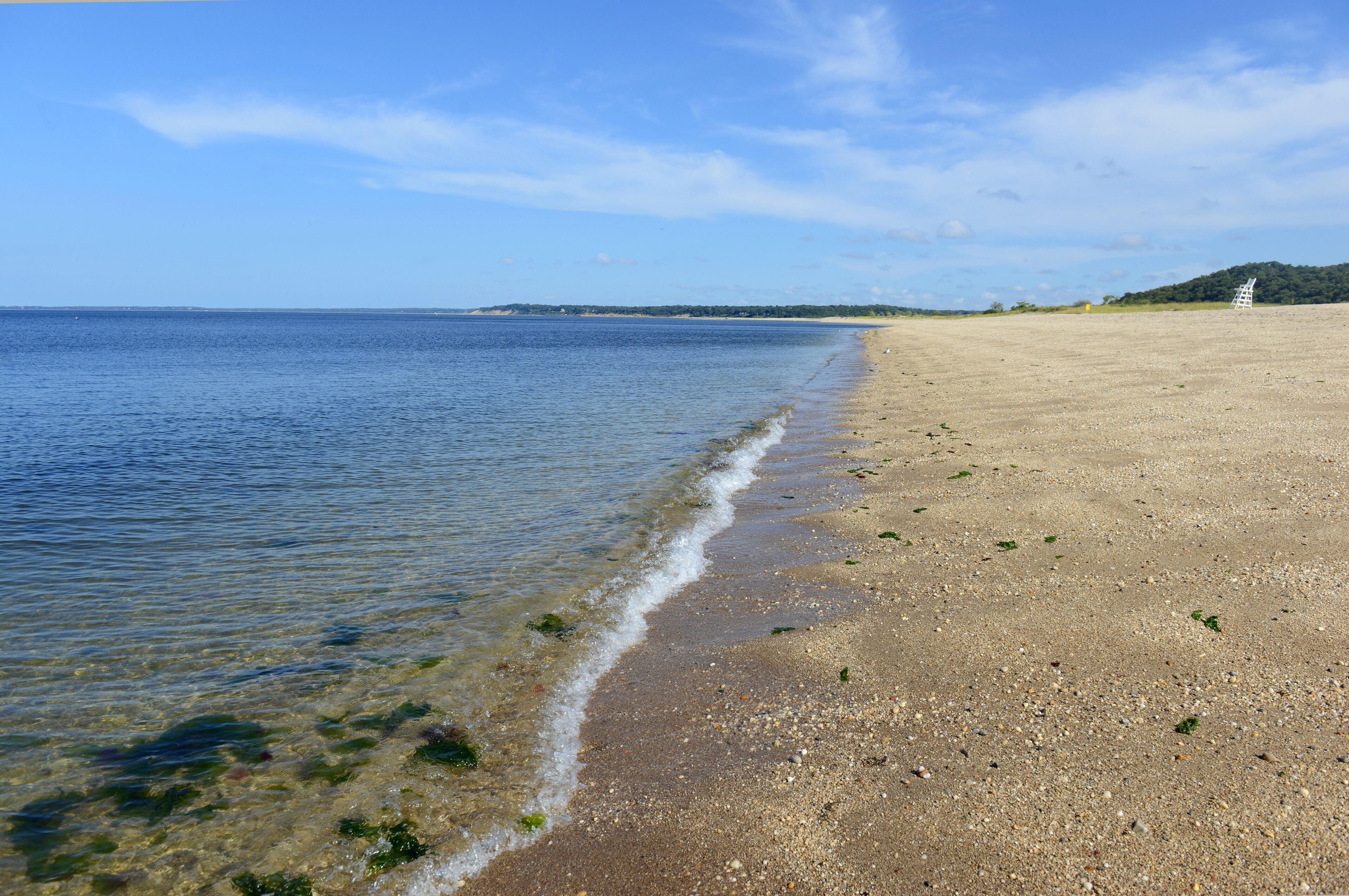 Sand beach on Long Island Sound, with blue skies and no people. New York