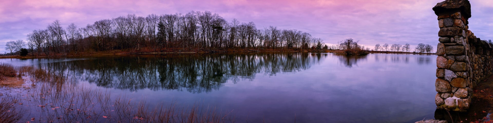 Greenwich Point Park Nature Preserve Sunrise Seascape at Tod's Inlet and Flat Neck Point with an island with Eagle and Osprey Nests, and a stonewall post in Old Greenwich, Connecticut, USA