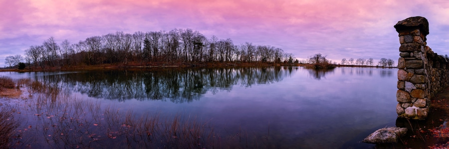Greenwich Point Park Nature Preserve Sunrise Seascape at Tod's Inlet and Flat Neck Point with an island with Eagle and Osprey Nests, and a stonewall post in Old Greenwich, Connecticut, USA