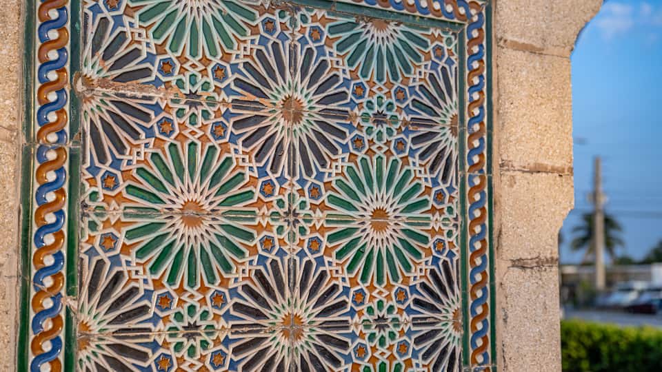 A detailed tile mosaic with geometric patterns and star shapes.