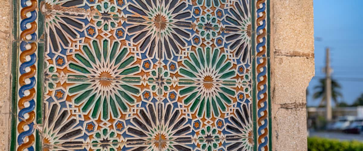A detailed tile mosaic with geometric patterns and star shapes.