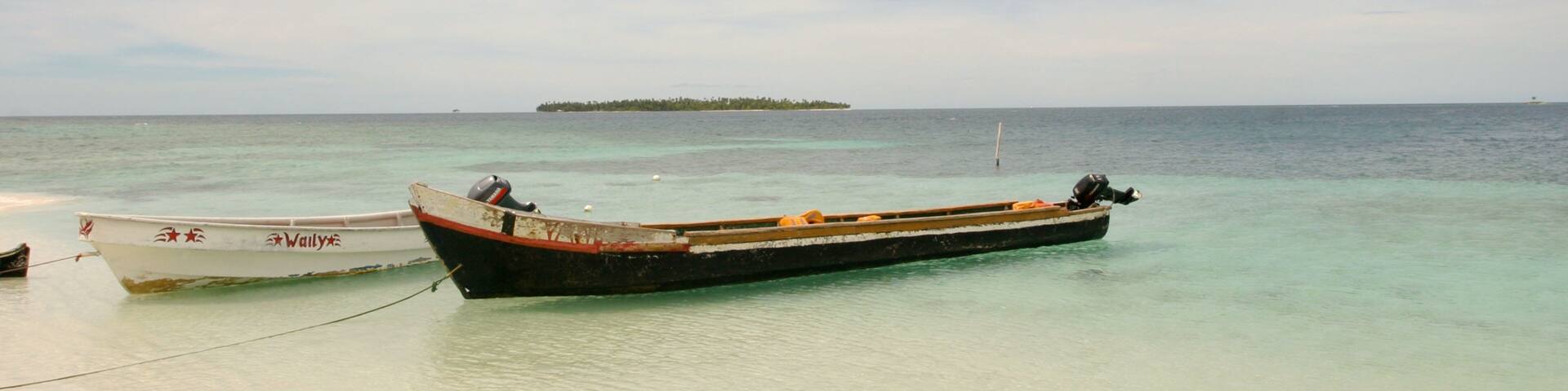 A beach with two boats tied to the shore.