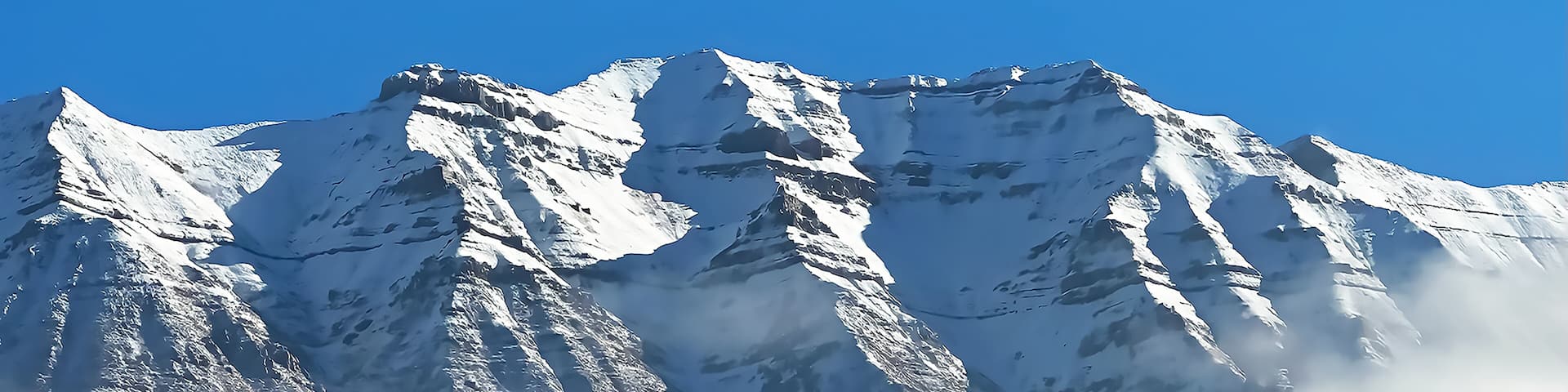Mount Timpanogos rising above the clouds on a clear winter day