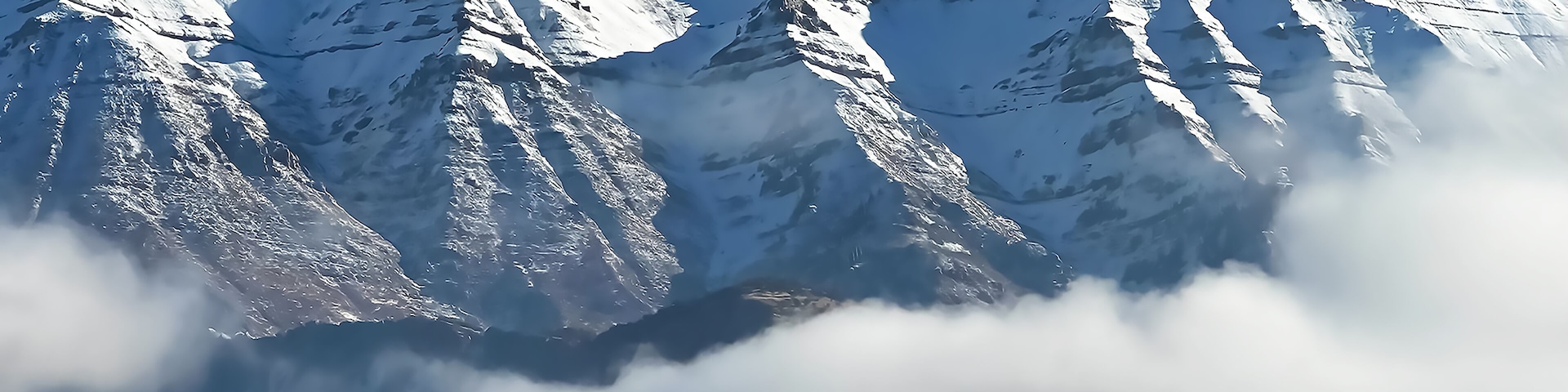 Mount Timpanogos rising above the clouds on a clear winter day