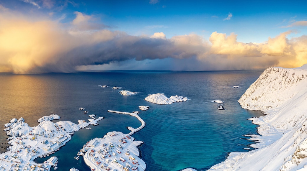 Burning sky at sunrise over the cold sea and Sorvaer village covered with snow, Soroya Island, Hasvik, Troms og Finnmark, Arctic