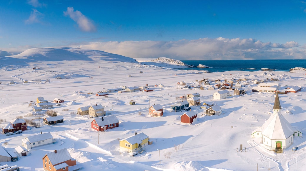 Aerial view of traditional houses and church in the small village of Hasvik after a snowfall, Troms og Finnmark
