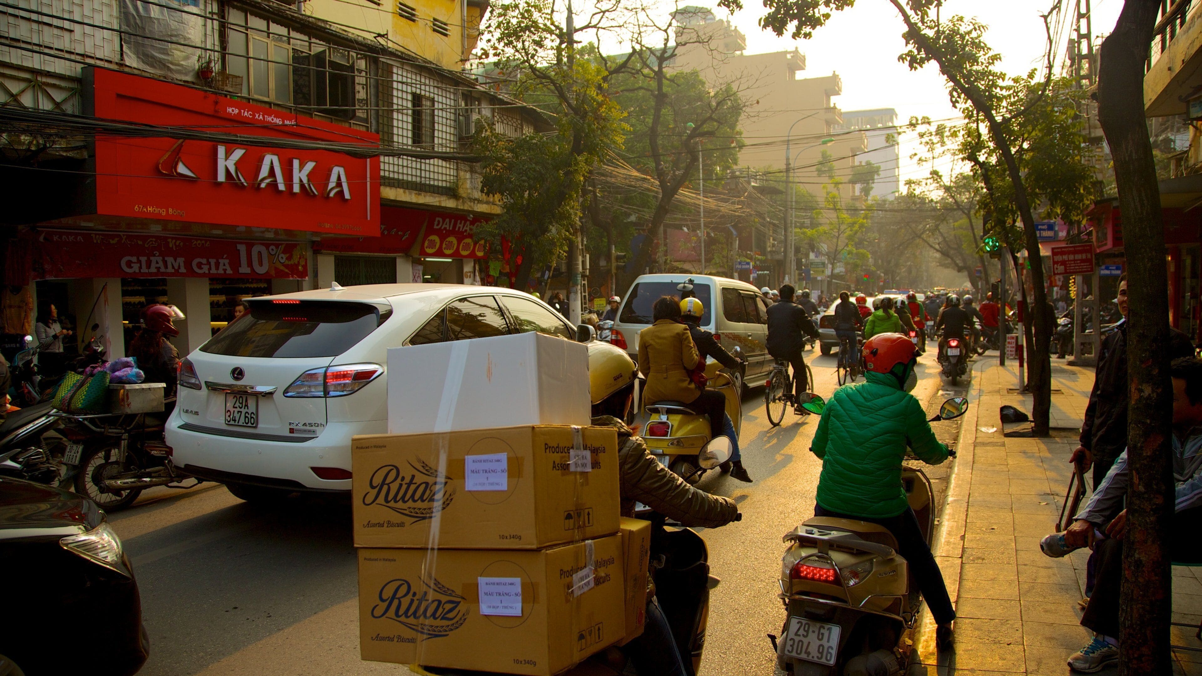 Hanoi which includes a city, motorbike riding and signage